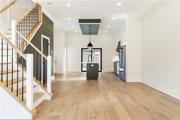 a view of a hallway with wooden floor and staircase