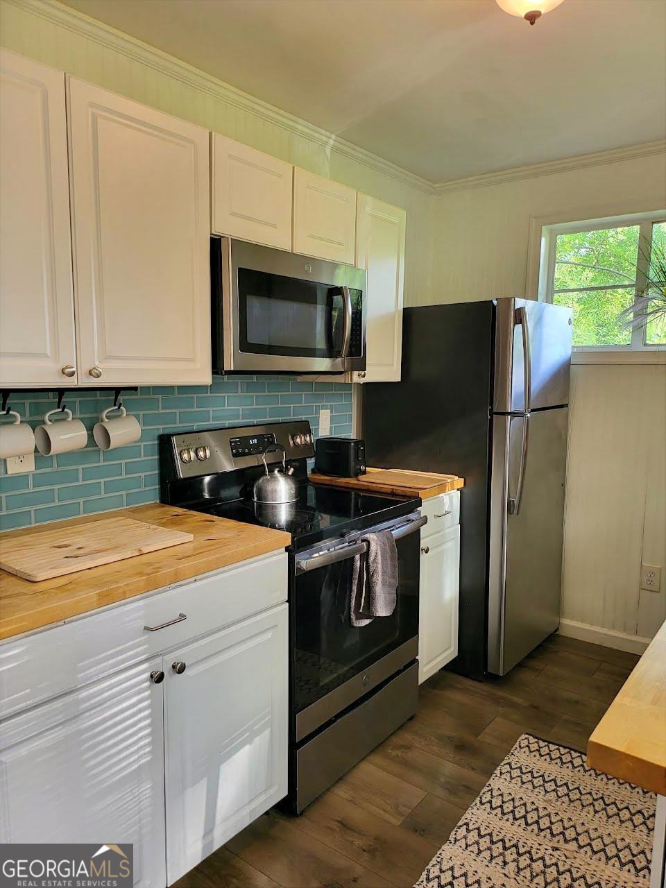 406 Pinelea Road Griffin, GA 30223 - Photo 35 of 53 a kitchen with stainless steel appliances granite countertop a stove a refrigerator a sink a microwave and cabinets