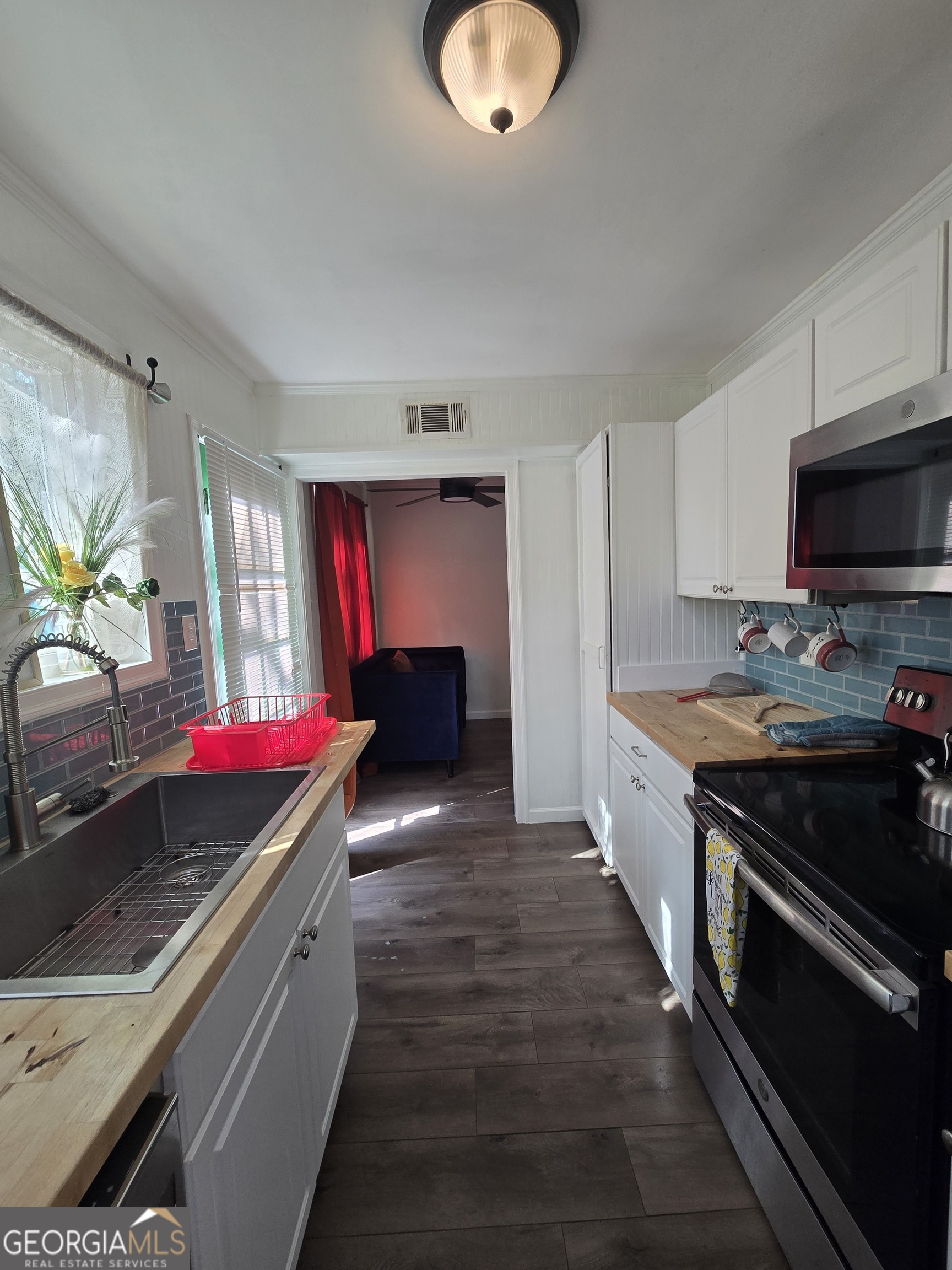 406 Pinelea Road Griffin, GA 30223 - Photo 42 of 53 a kitchen with stainless steel appliances granite countertop a stove and a sink
