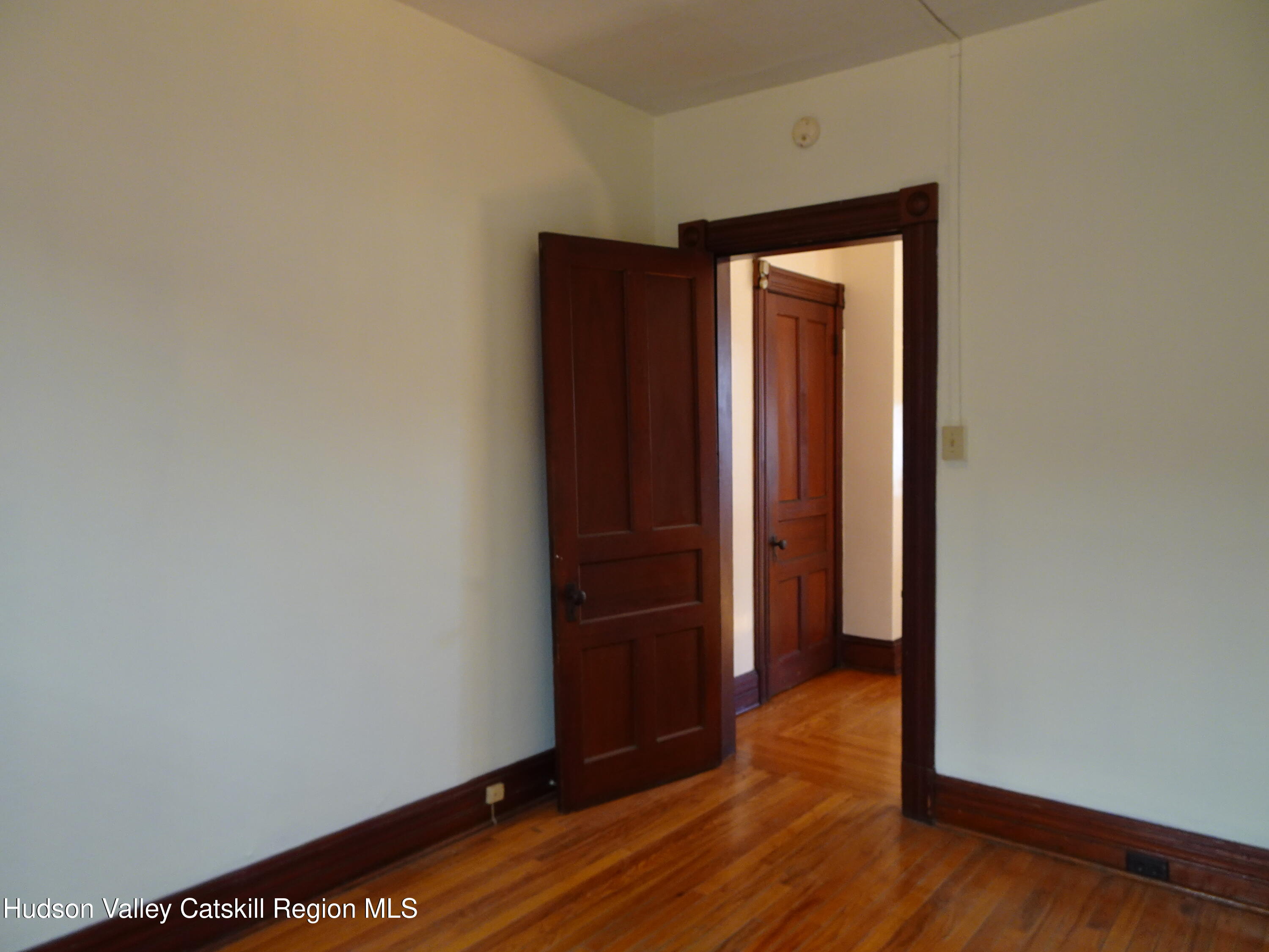32-34 8th Street, Unit 1 Hudson, NY 12534 - Photo 13 of 14 a view of an empty room with wooden floor and closet