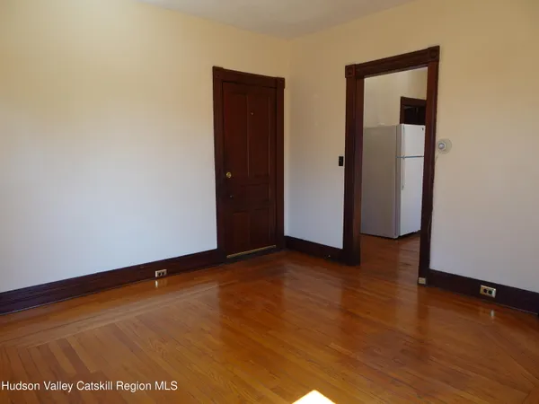 an empty room with wooden floor and closet
