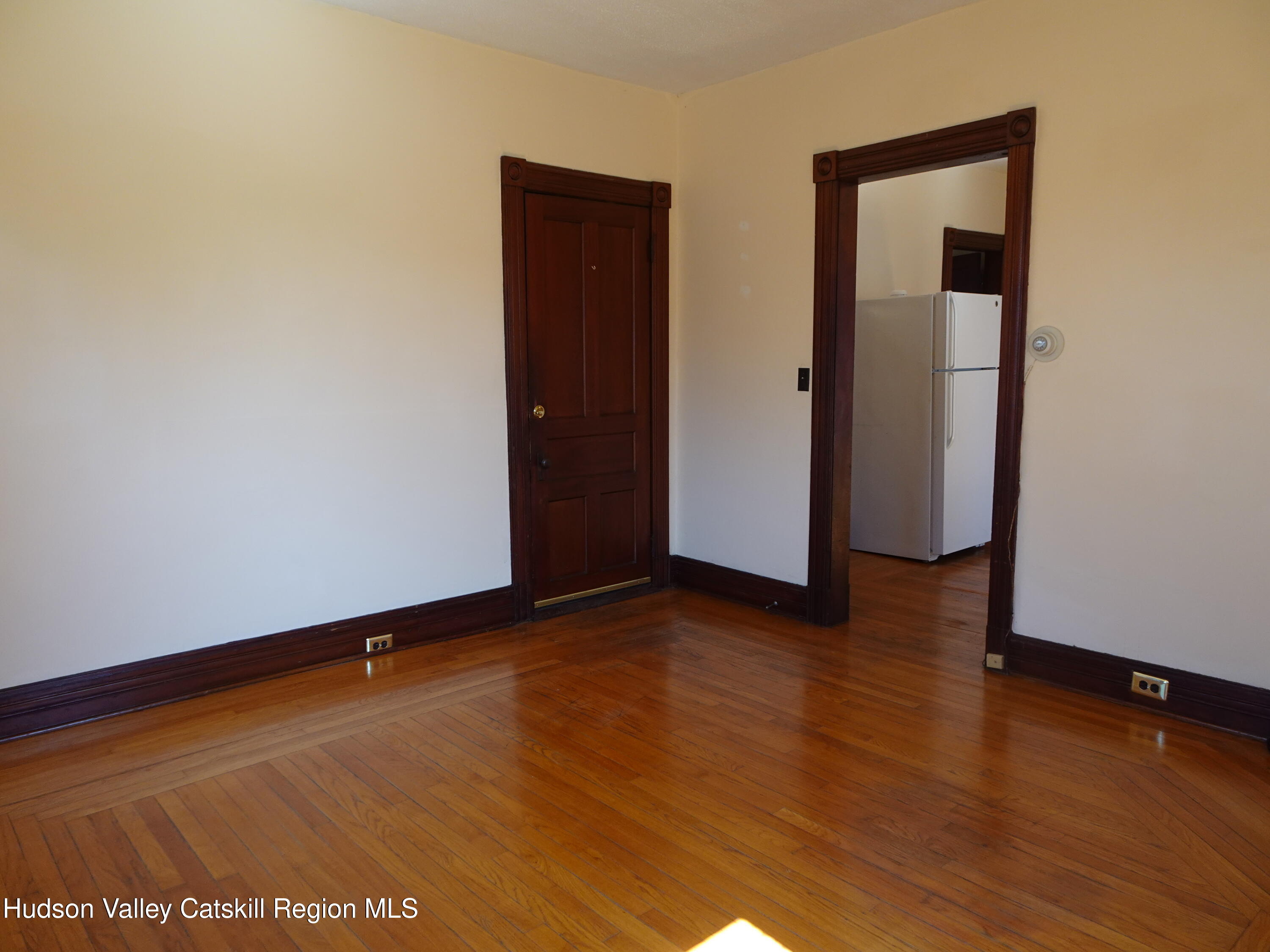 32-34 8th Street, Unit 1 Hudson, NY 12534 - Photo 7 of 14 an empty room with wooden floor and closet