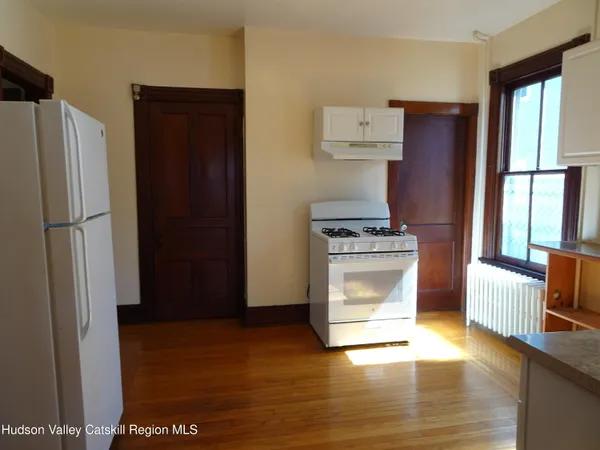 a kitchen with granite countertop a refrigerator and a stove