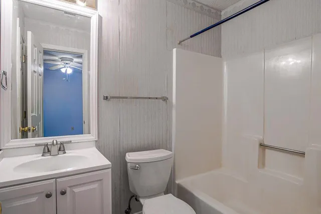 a white toilet sitting next to a bathroom sink