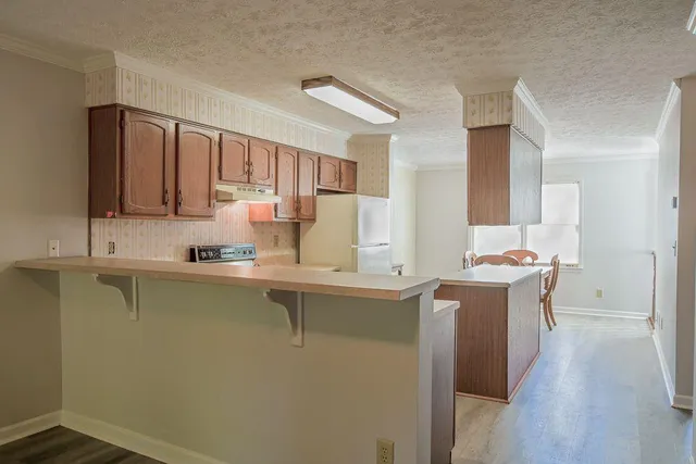 a kitchen with a sink stove and cabinets