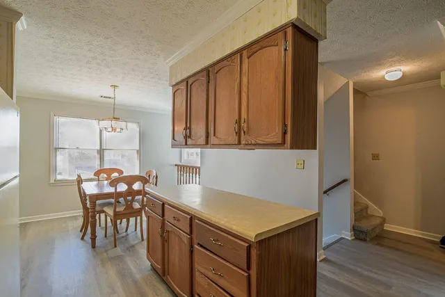 a kitchen that has a table and chairs in it