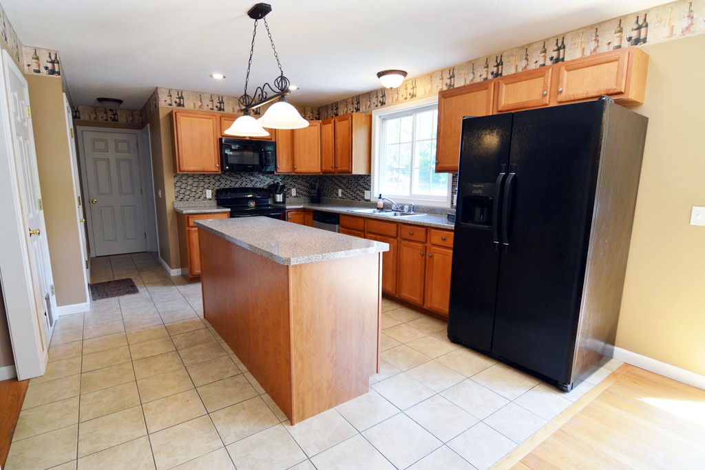 187 Lucerne Road Springfield, MA 01119 - Photo 4 of 30 a kitchen with stainless steel appliances granite countertop a refrigerator and a wooden floor