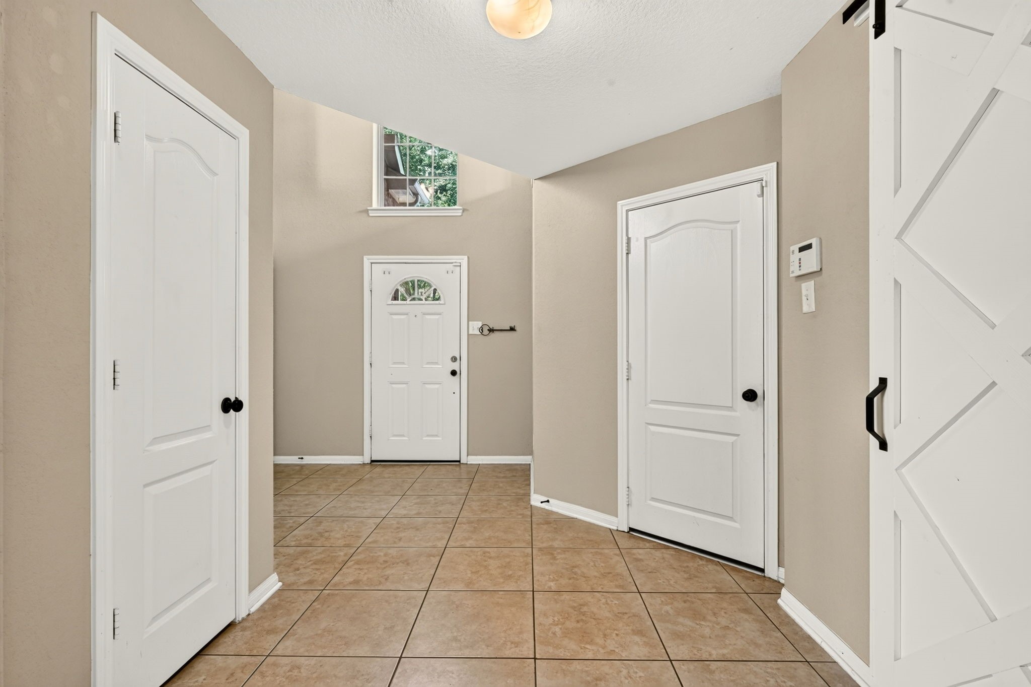 6446 Tea Tree Drive Katy, TX 77494 - Photo 9 of 39 Looking back at the front door we can see the door to the closet on the left and door to the garage on the right and kitchen is on the far right.