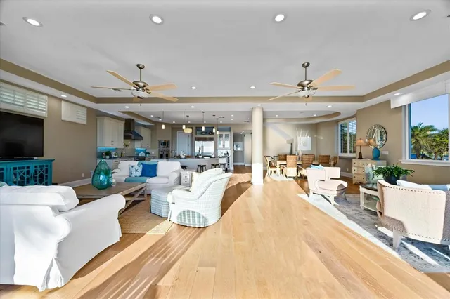 a living room with furniture kitchen view and a potted plant