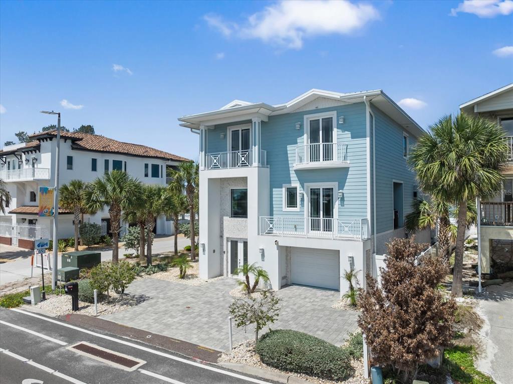 2 Gulf Boulevard Indian Rocks Beach, FL 33785 - Photo 2 of 79 a front view of a house with a garden