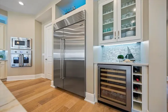 a bathroom with a granite countertop sink a mirror and shower