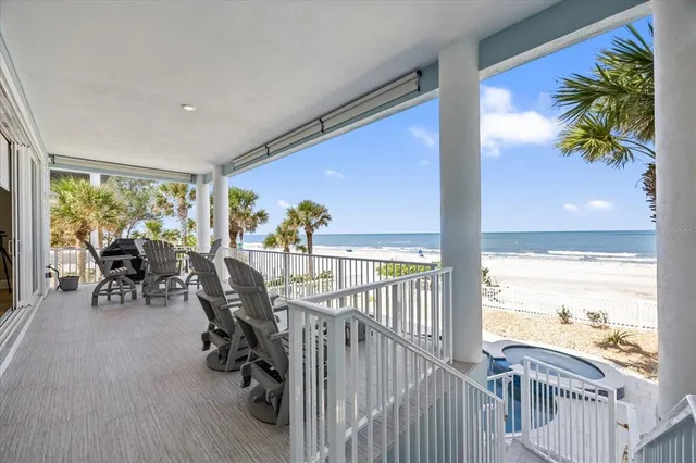 a spacious bedroom with a large bed and a chandelier