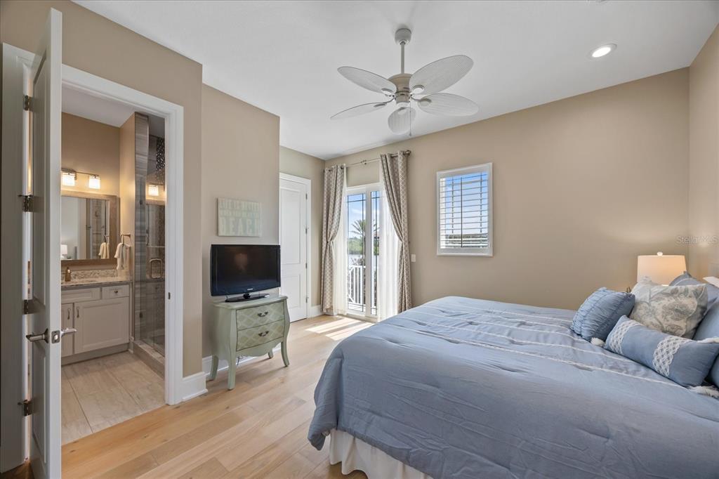 2 Gulf Boulevard Indian Rocks Beach, FL 33785 - Photo 34 of 79 a bedroom with a bed and a flat screen tv