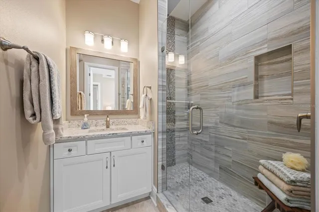 a bed sitting in a spacious bedroom next to a window