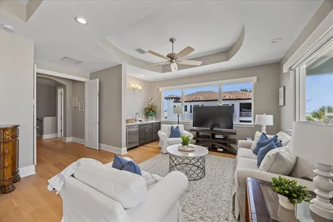 a view of a house with swimming pool and sitting area