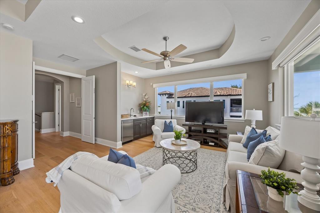 2 Gulf Boulevard Indian Rocks Beach, FL 33785 - Photo 47 of 79 a living room with furniture and a flat screen tv