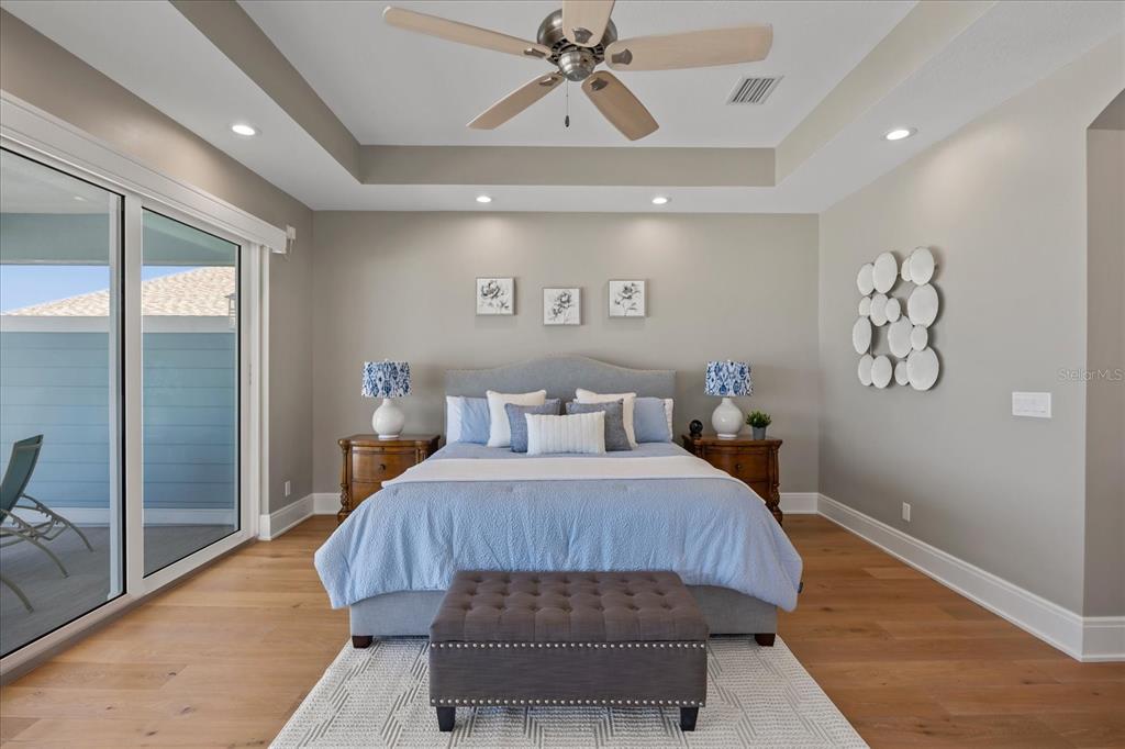 2 Gulf Boulevard Indian Rocks Beach, FL 33785 - Photo 48 of 79 a bedroom with a large bed and a chandelier