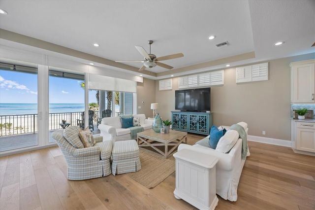 a living room with fireplace furniture and a wooden floor