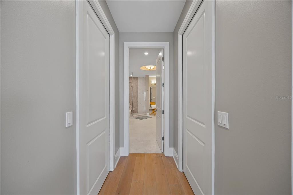 2 Gulf Boulevard Indian Rocks Beach, FL 33785 - Photo 58 of 79 a view of a hallway with a livingroom and a bathroom with sink