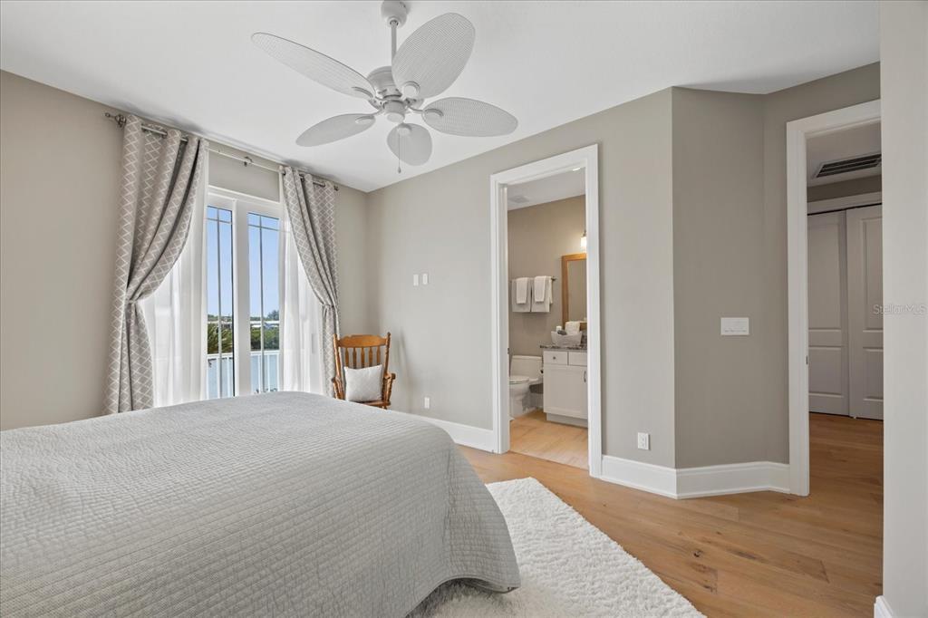 2 Gulf Boulevard Indian Rocks Beach, FL 33785 - Photo 68 of 79 a bedroom with a bed and a chandelier