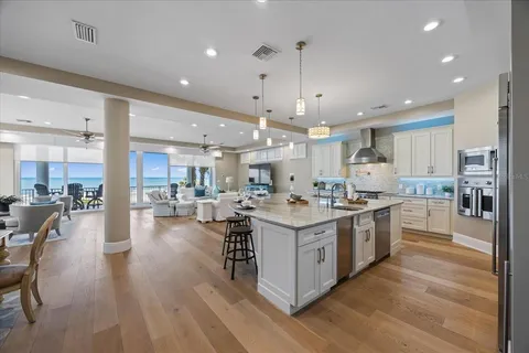 a living room with furniture a fireplace and a chandelier