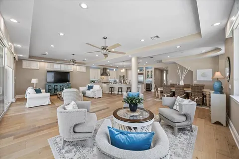 a view of a dining room with furniture a chandelier and wooden floor