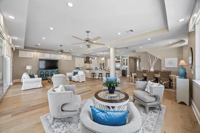 a view of a dining room with furniture a chandelier and wooden floor