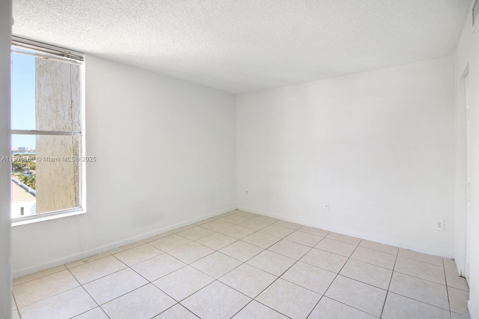 2350 Northeast 135th Street, Unit 1111 North Miami, FL 33181 - Photo 13 of 21 an empty room with windows