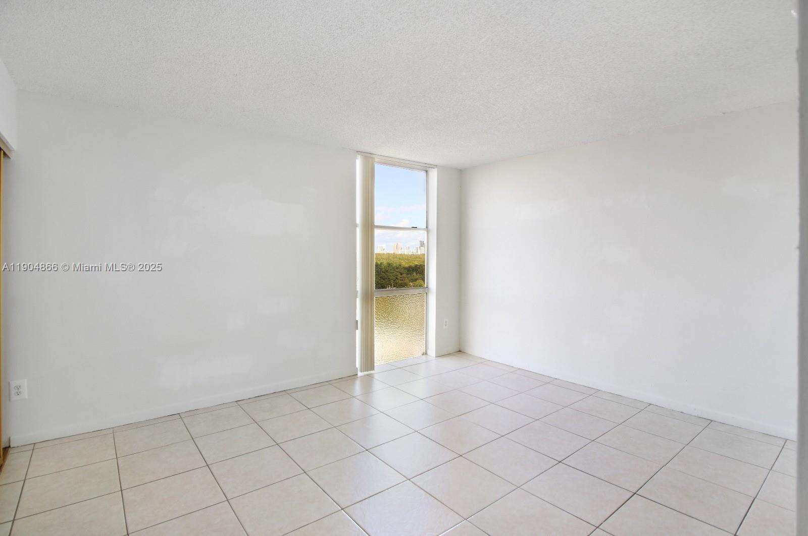 2350 Northeast 135th Street, Unit 1111 North Miami, FL 33181 - Photo 15 of 21 a view of an empty room and window