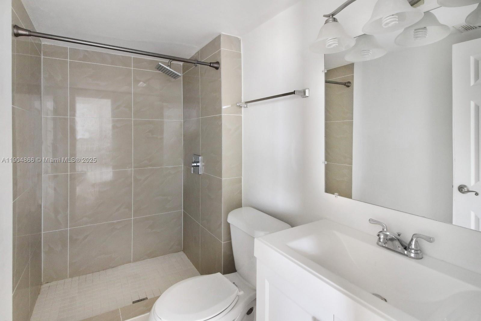 2350 Northeast 135th Street, Unit 1111 North Miami, FL 33181 - Photo 16 of 21 a bathroom with a sink toilet and shower