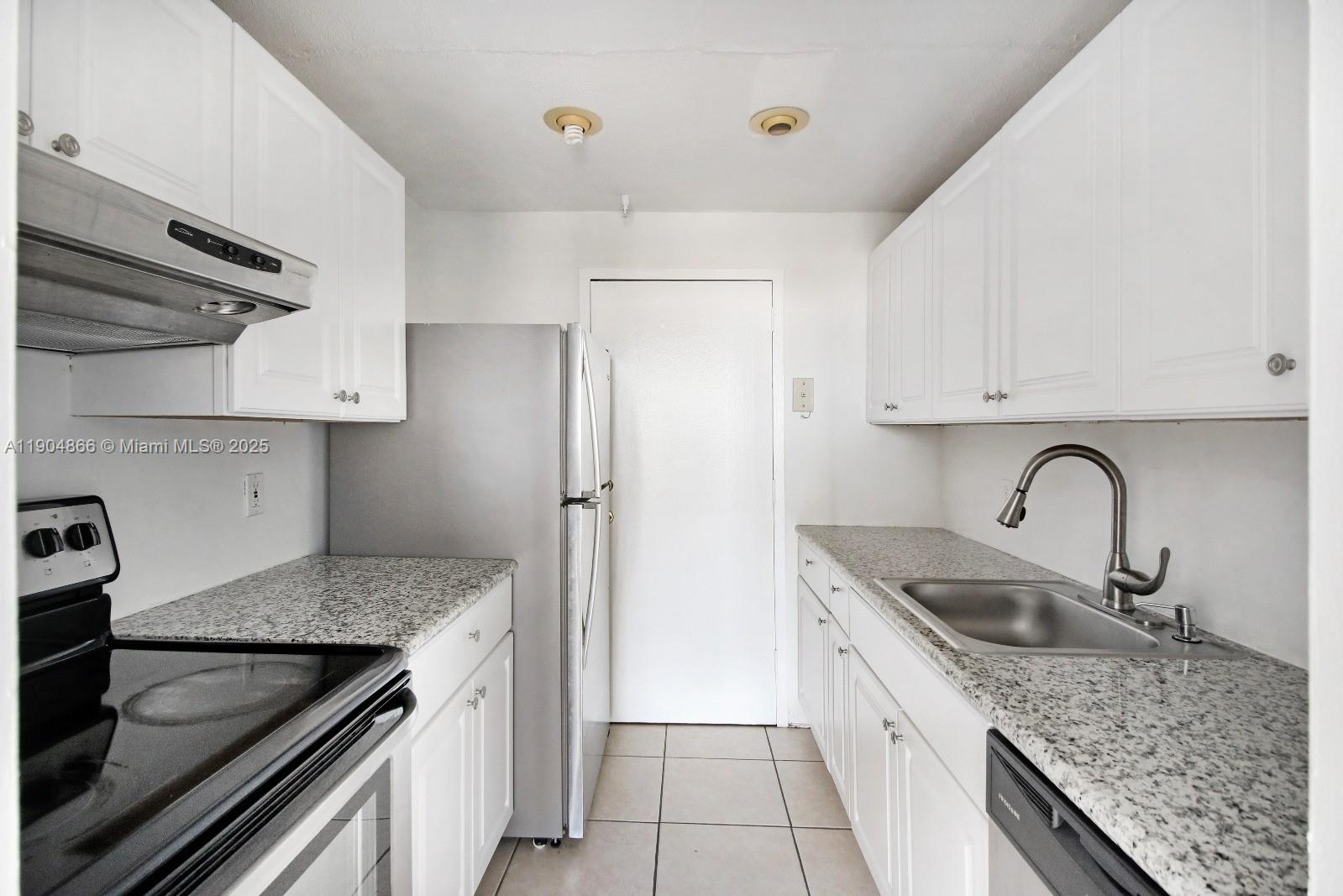 2350 Northeast 135th Street, Unit 1111 North Miami, FL 33181 - Photo 17 of 21 a kitchen with stainless steel appliances granite countertop a sink stove and refrigerator