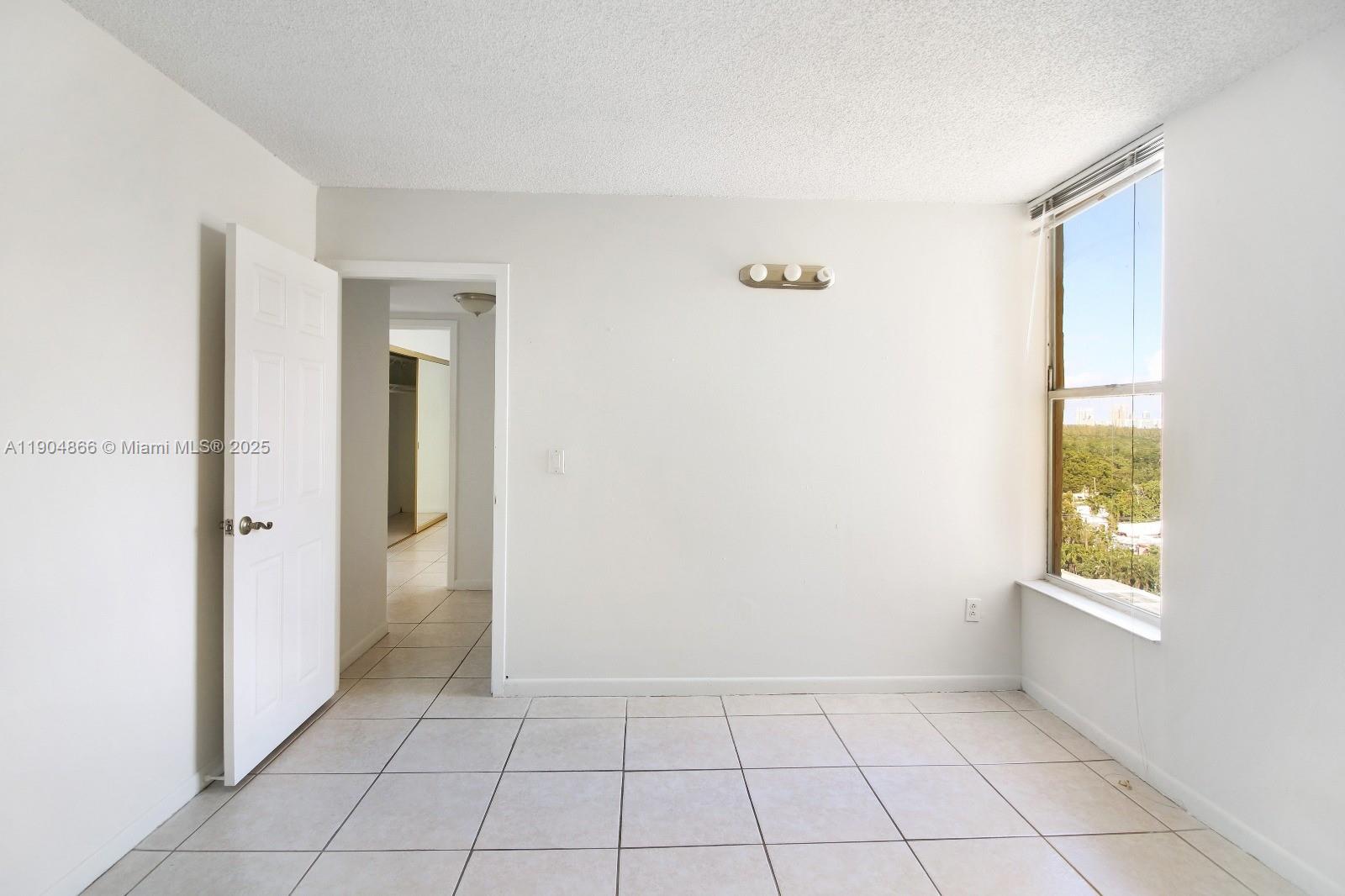 2350 Northeast 135th Street, Unit 1111 North Miami, FL 33181 - Photo 19 of 21 a view of an empty room and window