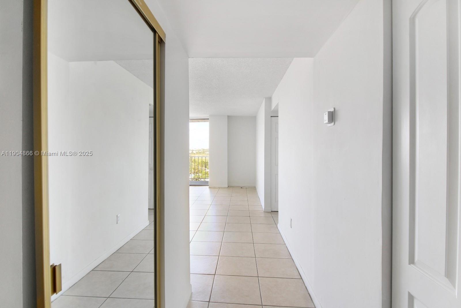 2350 Northeast 135th Street, Unit 1111 North Miami, FL 33181 - Photo 20 of 21 a view of a hallway with a dining area