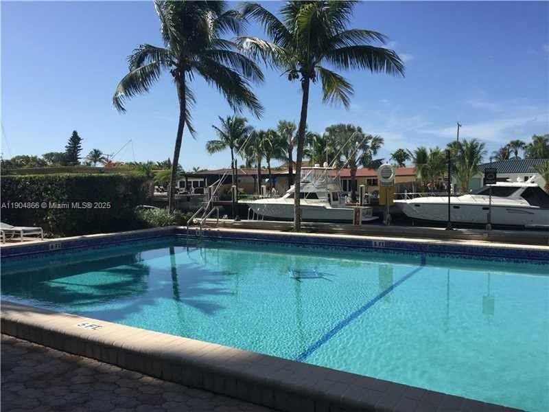 2350 Northeast 135th Street, Unit 1111 North Miami, FL 33181 - Photo 3 of 21 a view of outdoor space with swimming pool