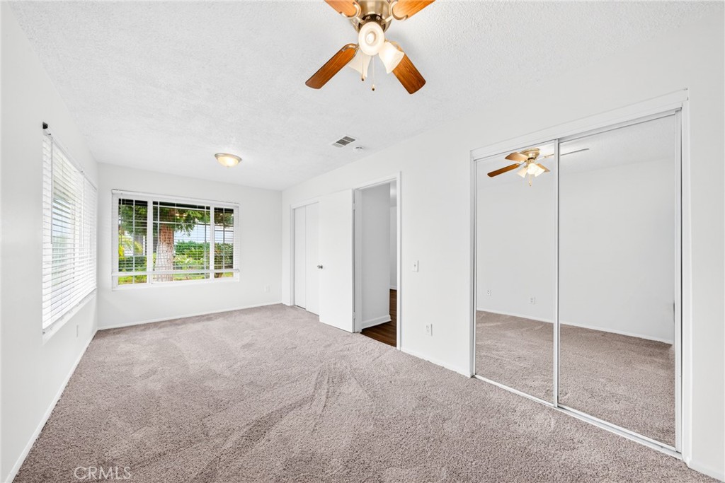 24867 Bower Street Moreno Valley, CA 92553 - Photo 13 of 46 a view of a room with a ceiling fan and a window