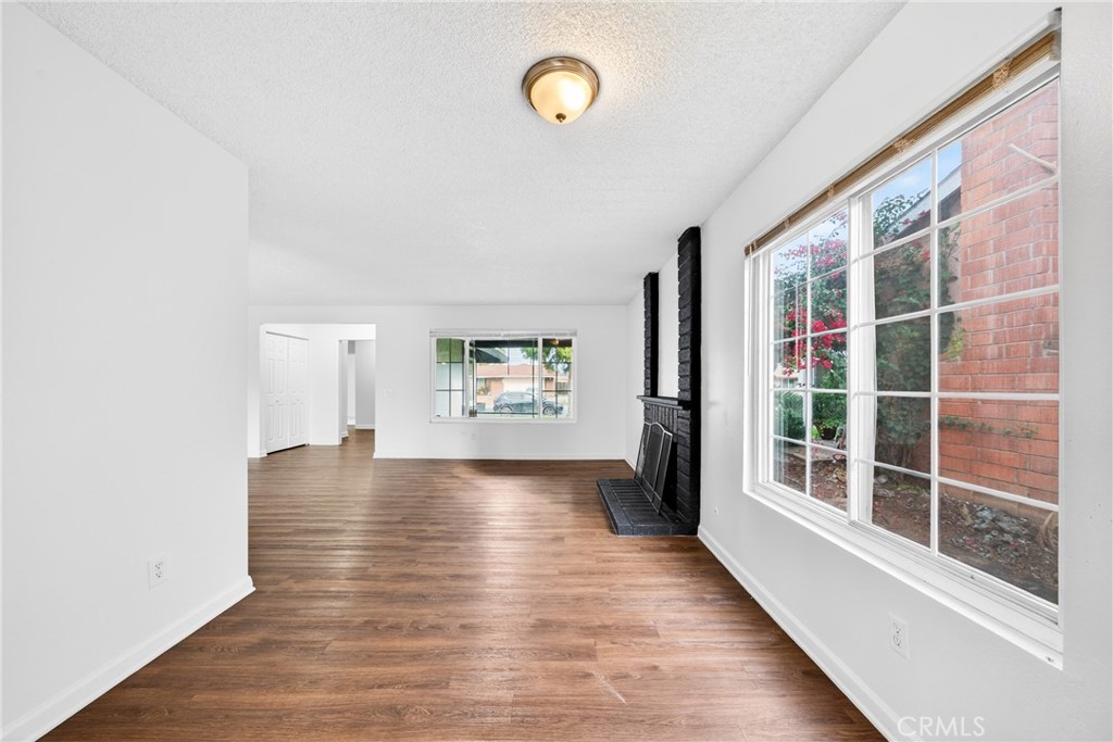 24867 Bower Street Moreno Valley, CA 92553 - Photo 26 of 46 a view of an empty room with wooden floor and a window