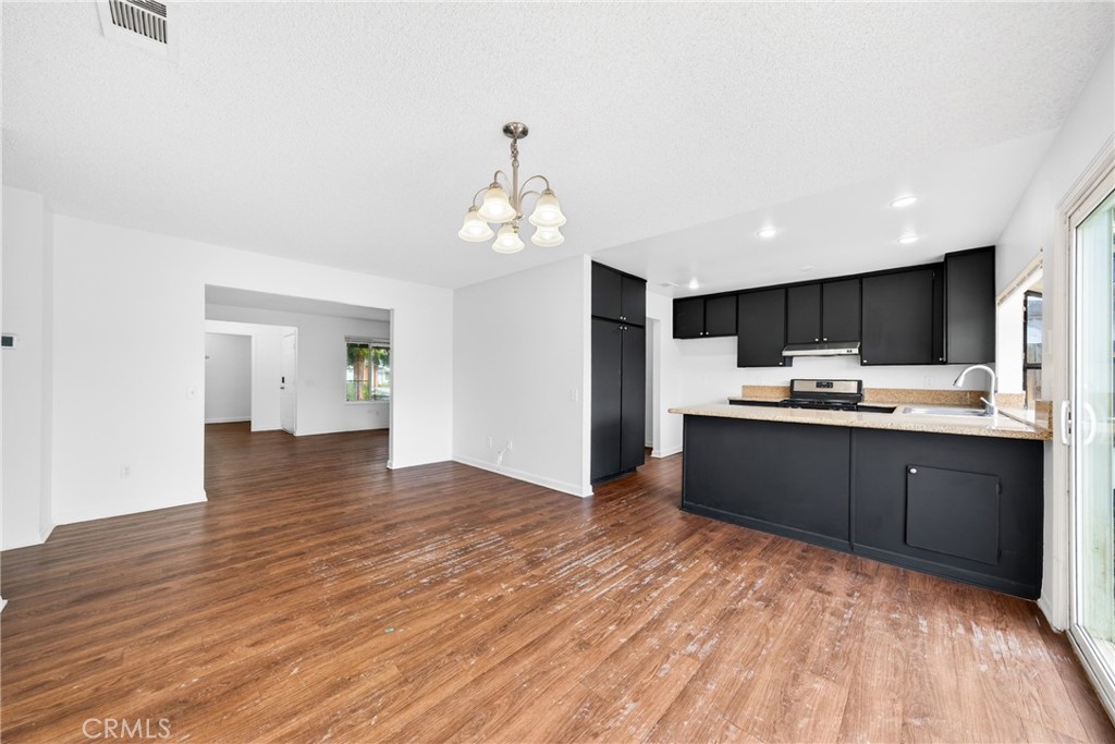 24867 Bower Street Moreno Valley, CA 92553 - Photo 28 of 46 a kitchen with stainless steel appliances granite countertop a sink and cabinets
