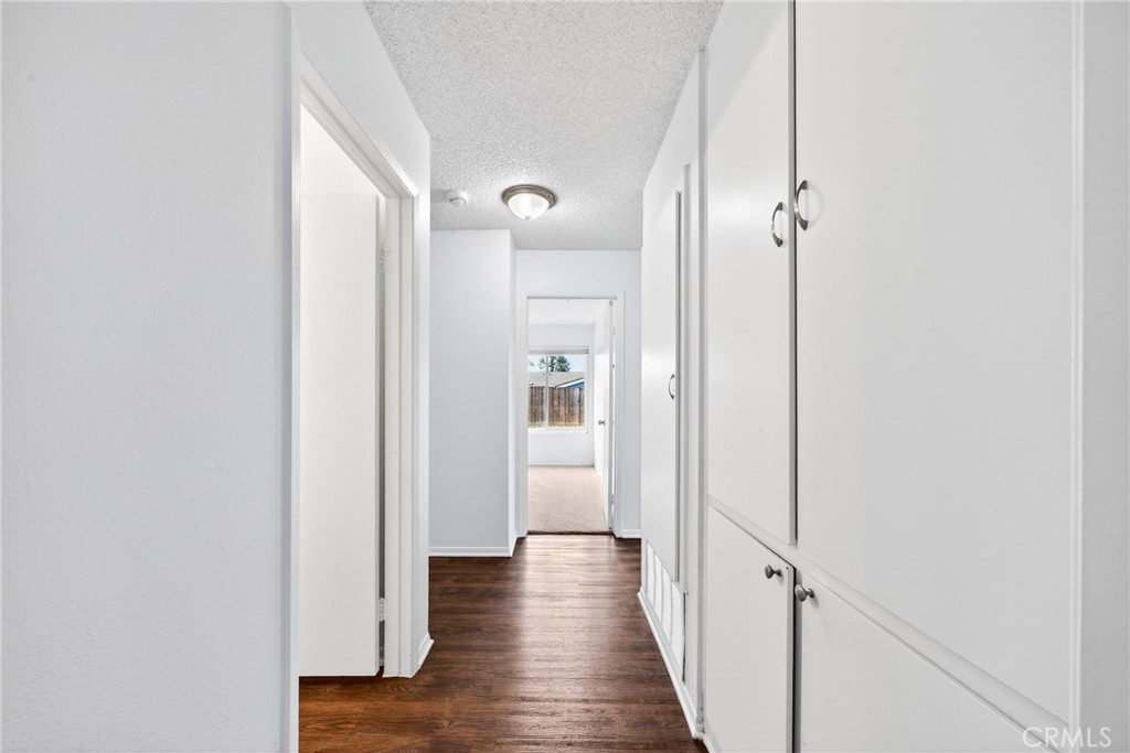 24867 Bower Street Moreno Valley, CA 92553 - Photo 30 of 46 a view of a hallway with wooden floor