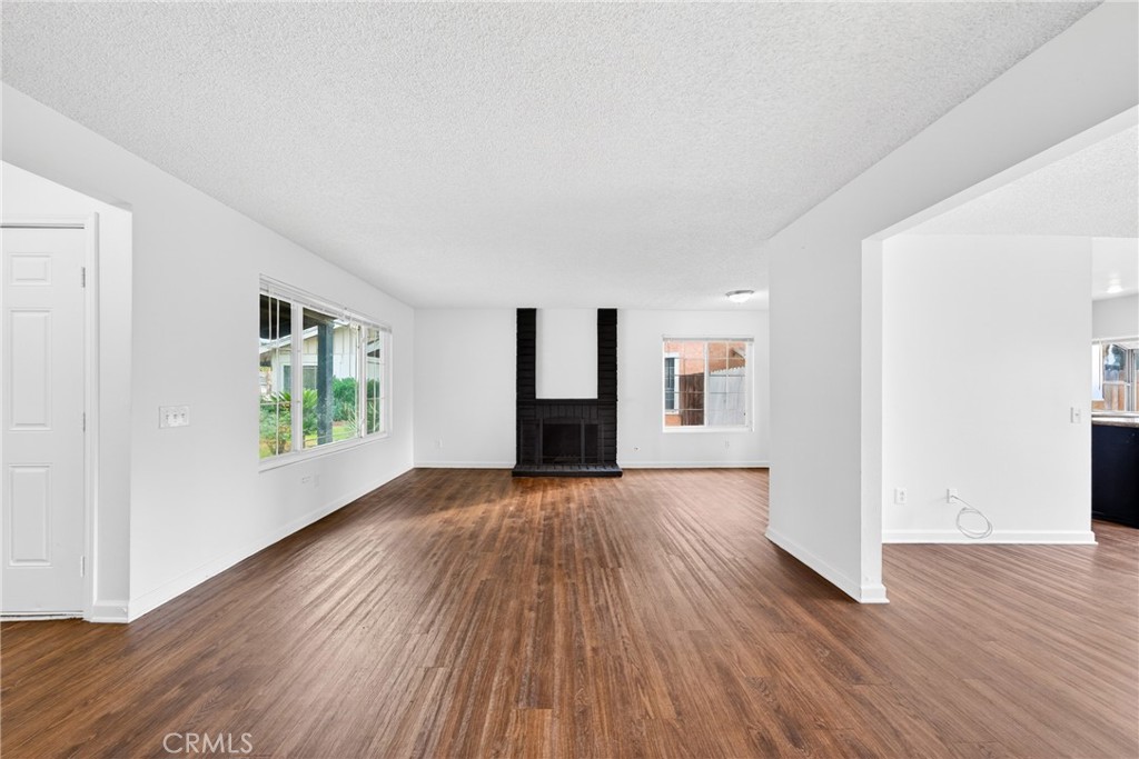 24867 Bower Street Moreno Valley, CA 92553 - Photo 3 of 46 an empty room with wooden floor and windows