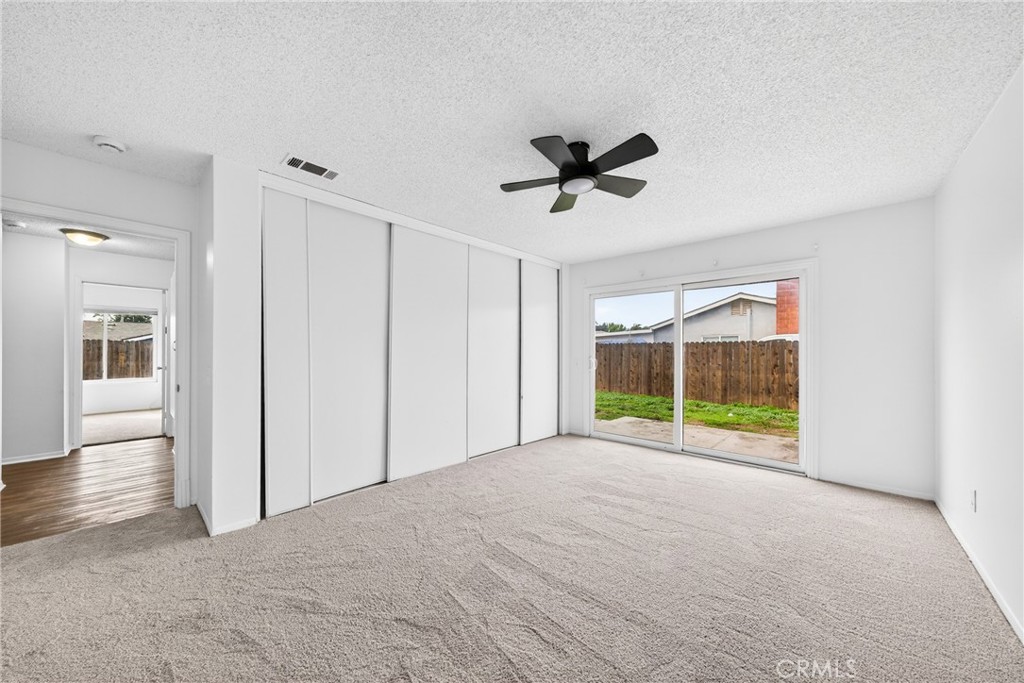24867 Bower Street Moreno Valley, CA 92553 - Photo 33 of 46 a view of empty room with wooden floor and fan