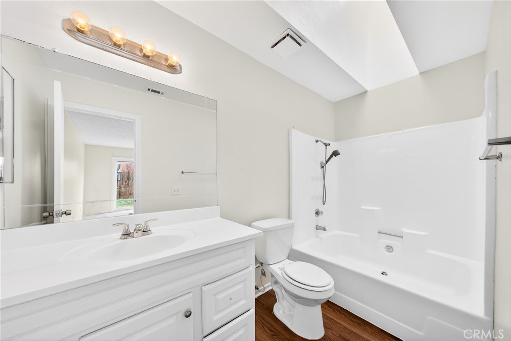 24867 Bower Street Moreno Valley, CA 92553 - Photo 35 of 46 a bathroom with a sink a toilet and a large mirror