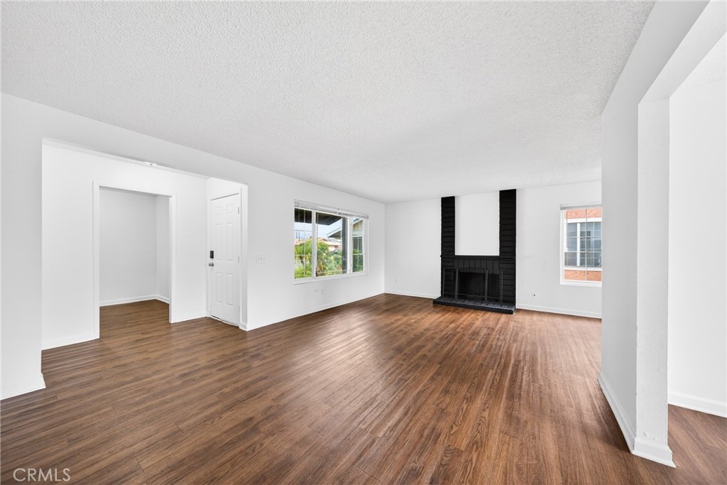 24867 Bower Street Moreno Valley, CA 92553 - Photo 4 of 46 a view of empty room with wooden floor and fireplace