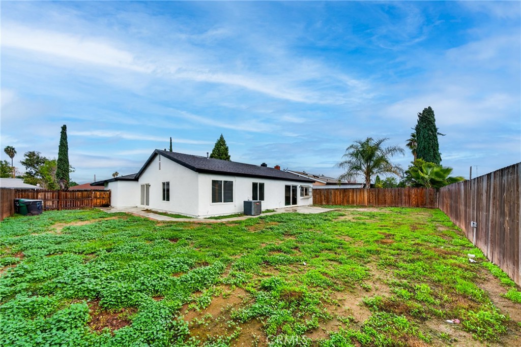 24867 Bower Street Moreno Valley, CA 92553 - Photo 45 of 46 a view of a house with a big yard plants and wooden fence