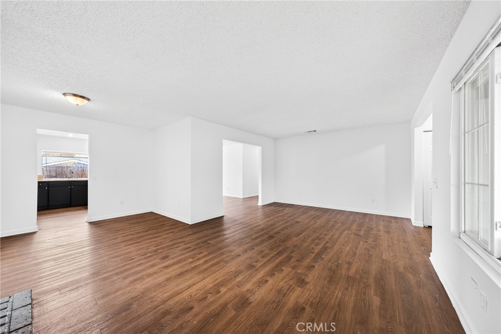 24867 Bower Street Moreno Valley, CA 92553 - Photo 7 of 46 a view of empty room with wooden floor and window