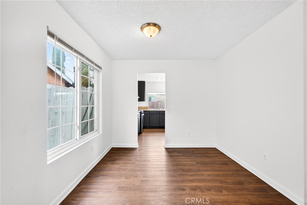 24867 Bower Street Moreno Valley, CA 92553 - Photo 8 of 46 a view of a hallway with wooden floor and windows