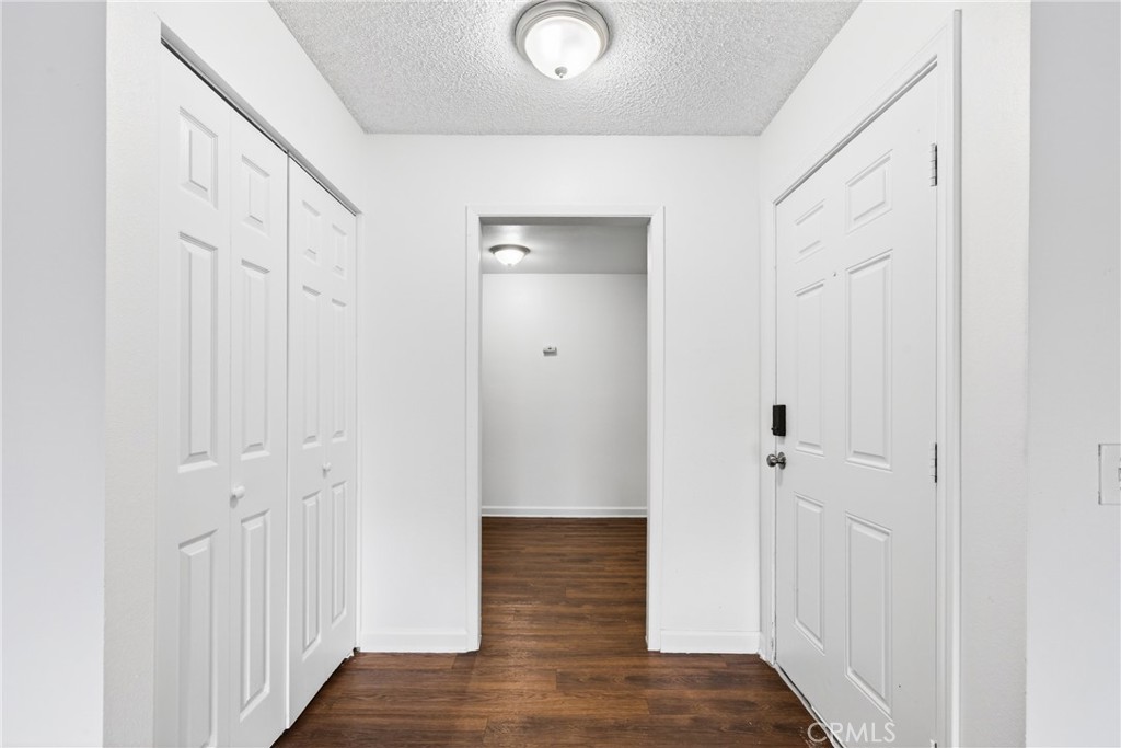 24867 Bower Street Moreno Valley, CA 92553 - Photo 9 of 46 a view of a hallway with wooden floor
