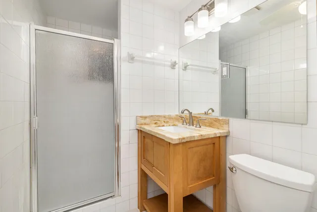 a bathroom with a sink toilet and shower