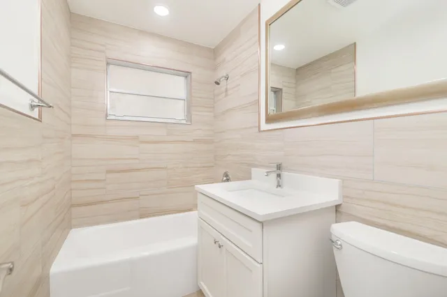 a bathroom with a sink a toilet and bathtub