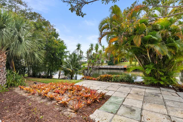 a group of people sitting in a yard with swimming pool