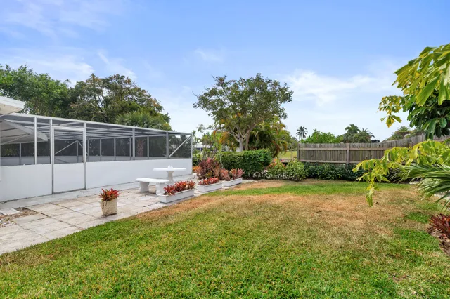 a view of a house with yard and lake view